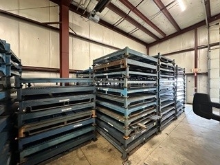Rows of disassembled stack racks stored in warehouse facility