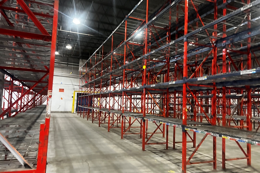 Used structural pallet racking bays configured for selective storage in distribution warehouse