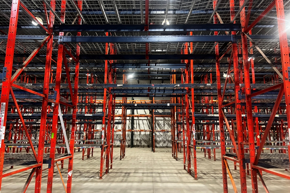 Industrial steel pallet rack uprights installed in distribution center warehouse