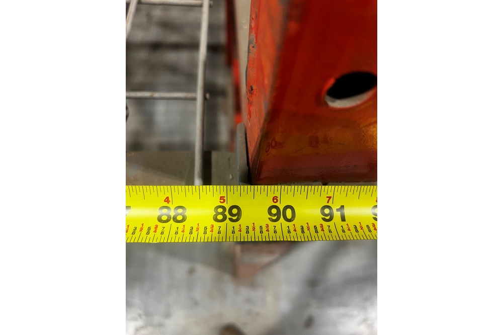92 inch bay width of structural pallet racking measured with tape measure showing beam span