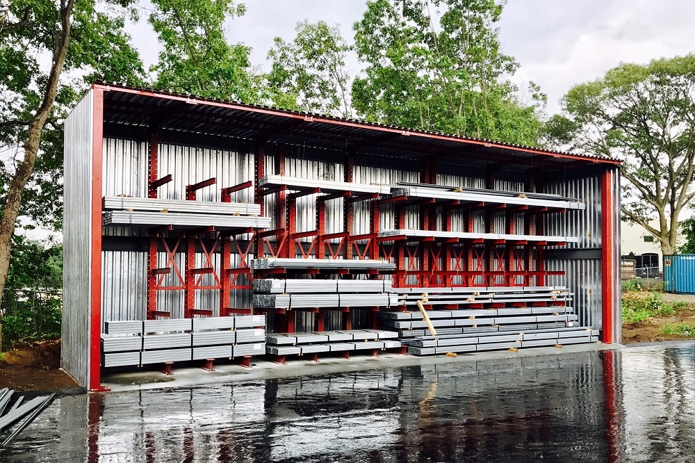 Used cantilever racking system available at American Surplus. Heavy-duty cantilever arms extend from vertical columns to store long materials like lumber, pipe, and tubing.