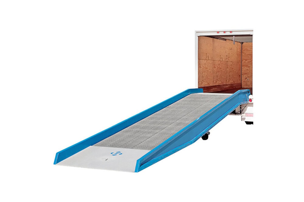 Blue ground-to-truck yard ramp positioned at the back of a box truck, featuring non-slip metal decking and side safety curbs for forklift access