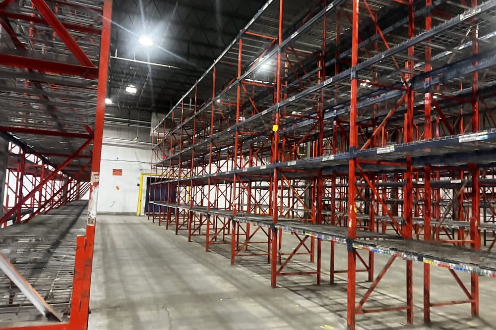 Used structural pallet racking bays configured for selective storage in distribution warehouse