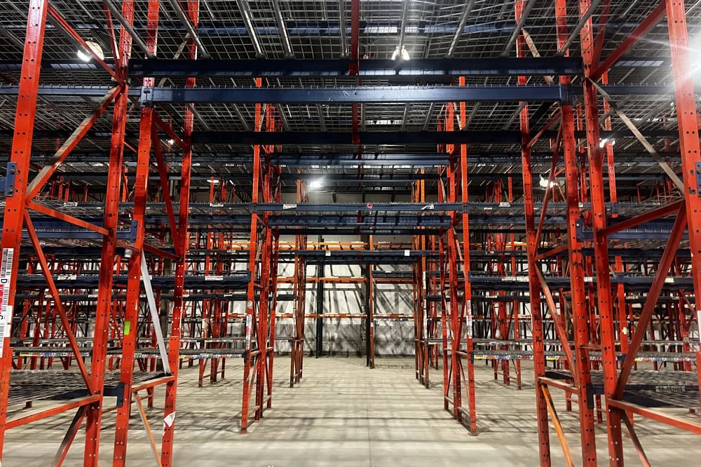 Industrial steel pallet rack uprights installed in distribution center warehouse