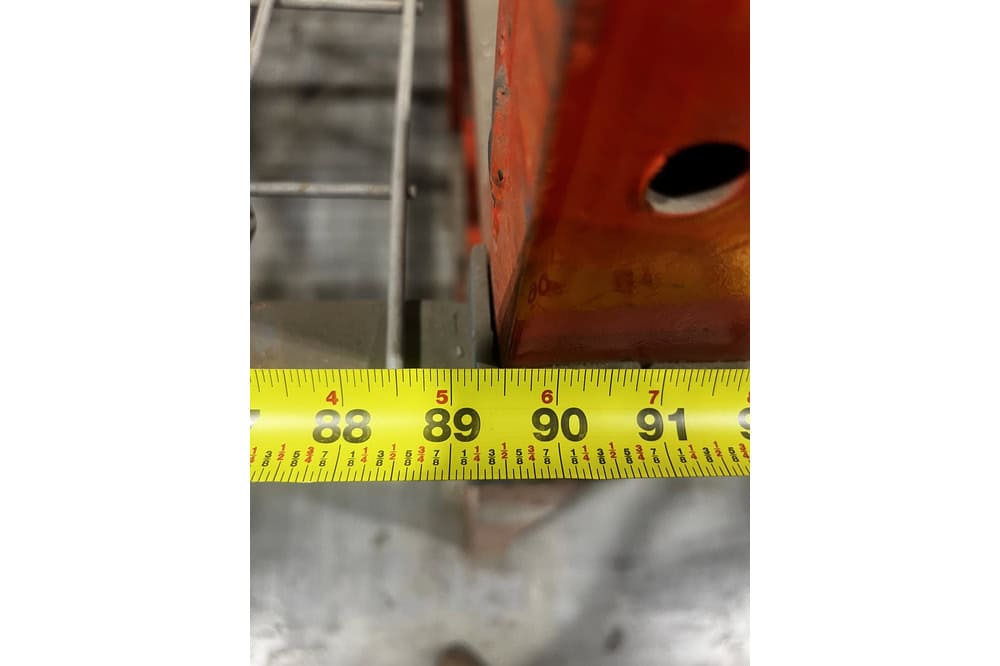 92 inch bay width of structural pallet racking measured with tape measure showing beam span