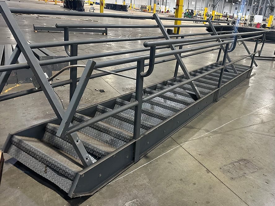 Grey Mezzanine Staircase liquidated from a facility in Randolph, Massachusetts by American Surplus