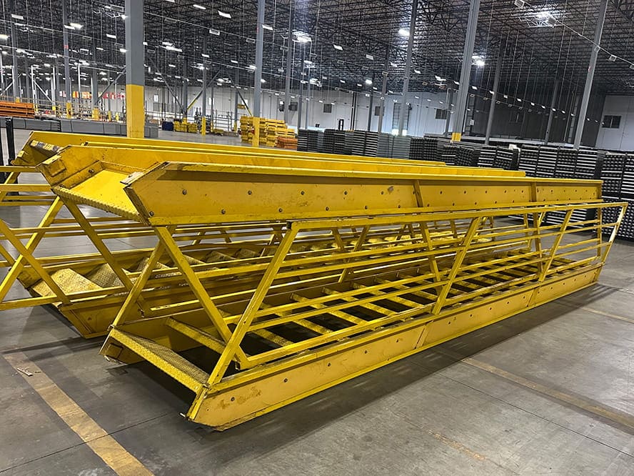 Yellow Mezzanine Staircases liquidated from a facility in Randolph, Massachusetts by American Surplus