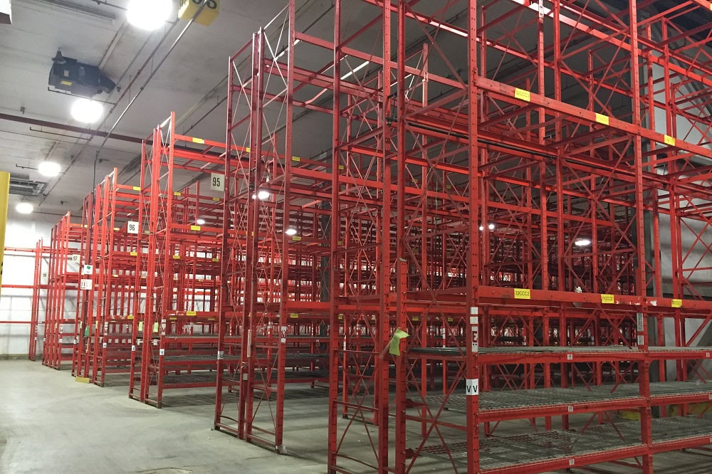Structural pallet racking system installed in a warehouse facility. Heavy-duty hot-rolled steel channels with bolted beam connections for high-capacity storage.